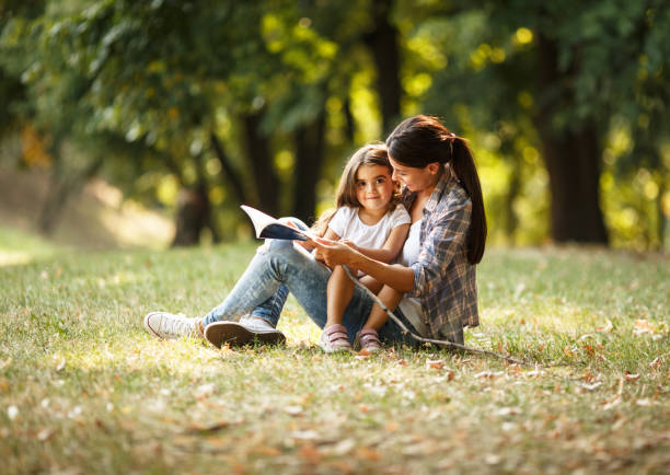 istock Mother and daughter relaxing in park. 670524660