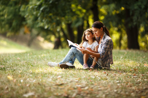 istock Mother and daughter relaxing in park. 670524664