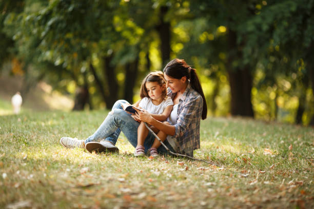 istock Mother and daughter relaxing in park. 670524938