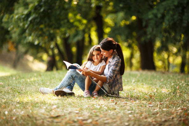 istock Mother and daughter relaxing in park. 670525038