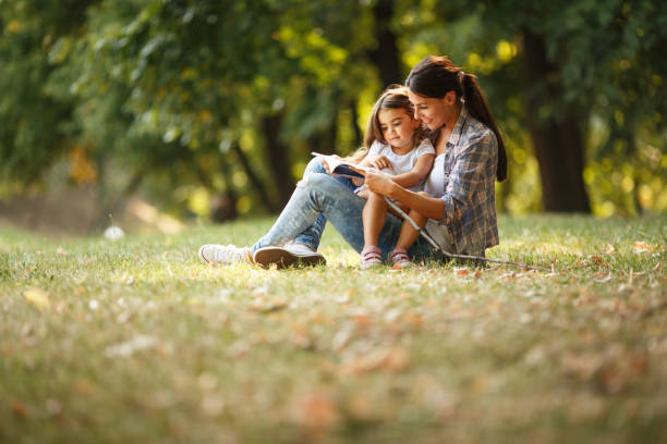 Mother and daughter relaxing in park.