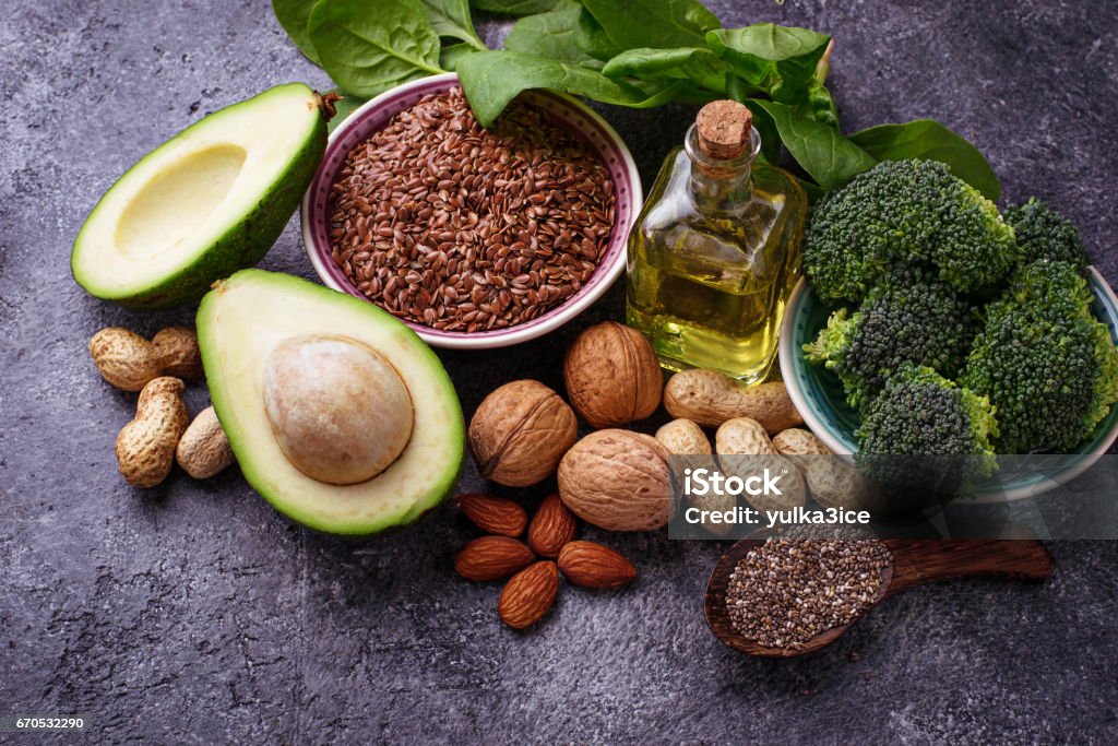 Concept of healthy food. Vegan fat sources Vegan fat sources â  flax, spinach, broccoli, nuts, olive, oil and avocado. Concept of healthy food Omega-3 Stock Photo