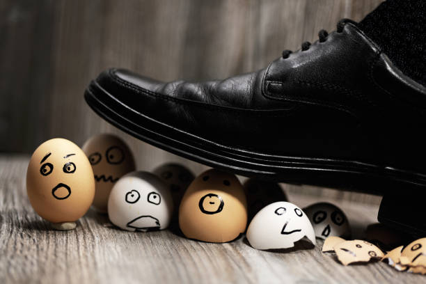 Abstract composition of business leadership. Abstract composition of business leadership. Broken eggs under mans shoes. egocentric stock pictures, royalty-free photos & images