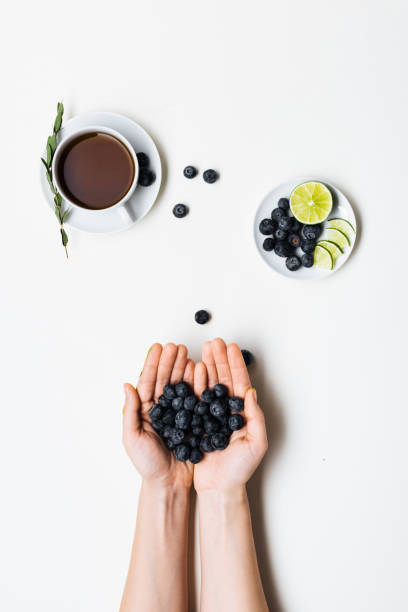 Fresh blueberries in hands still life top view