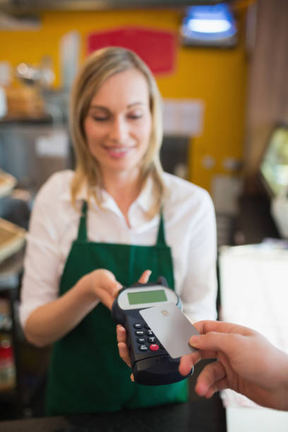 istock Female worker accepting payment through credit card 670540672