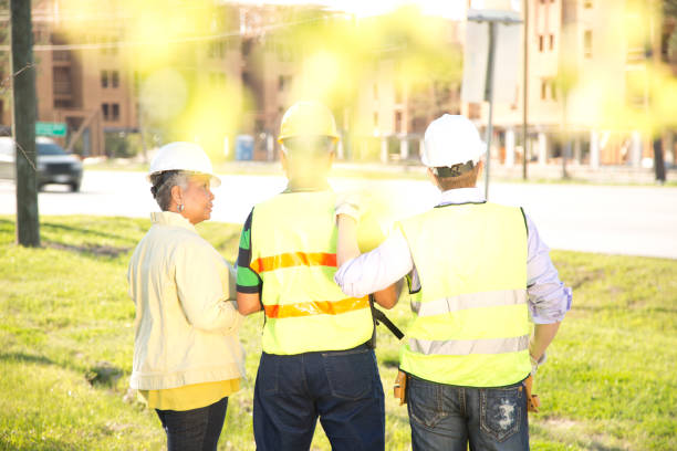istock Multi-ethnic team of construction engineer, architect and worker at job site. 670543964