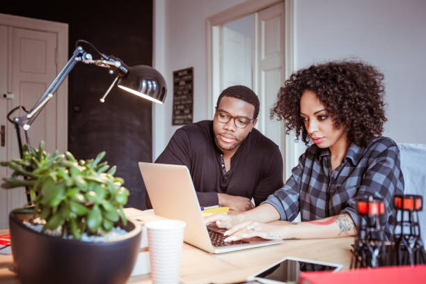 istock Couple of young designers using a laptop 670544286