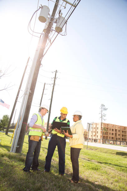 istock Multi-ethnic team of construction engineer, architect and worker at job site. 670544440