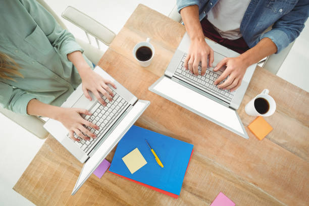 istock Midsection of man and woman using laptop 670557966