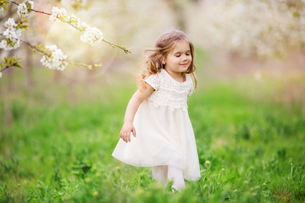 istock Pretty child girl in blossom spring garden 670560310