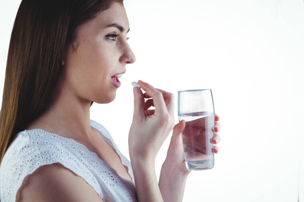 istock Pretty woman taking white pill 670560824
