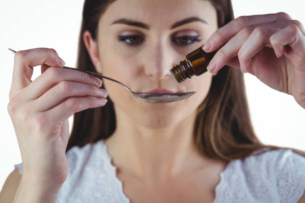 istock Pretty woman taking alternative tincture 670560924