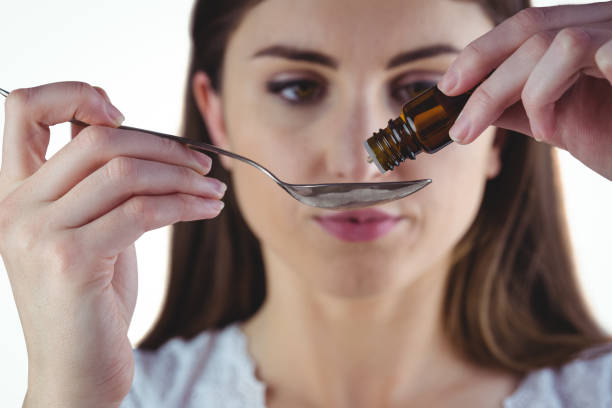 istock Pretty woman taking alternative tincture 670561208