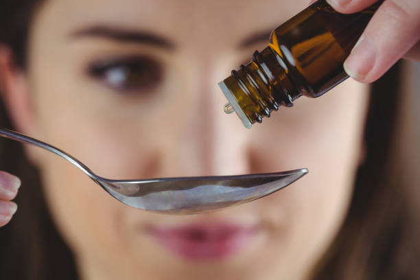 istock Pretty woman taking alternative tincture 670562988