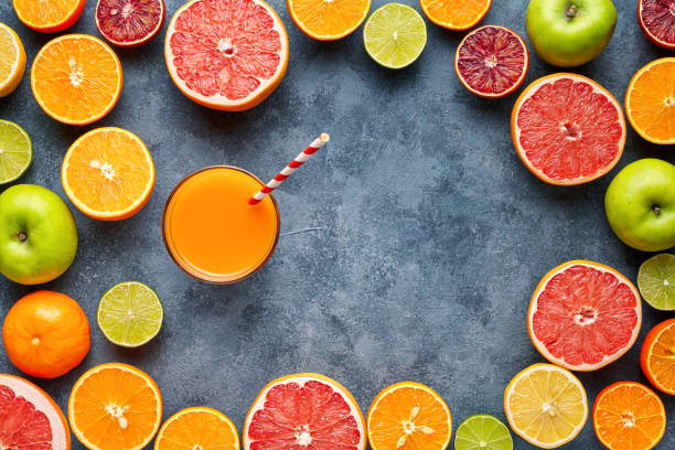 istock Juice with citrus fruit, apple, grapefruit on blue background. Top view, selective focus. Detox, dieting, clean eating, vegetarian, vegan, fitnes healthy concept 670563508