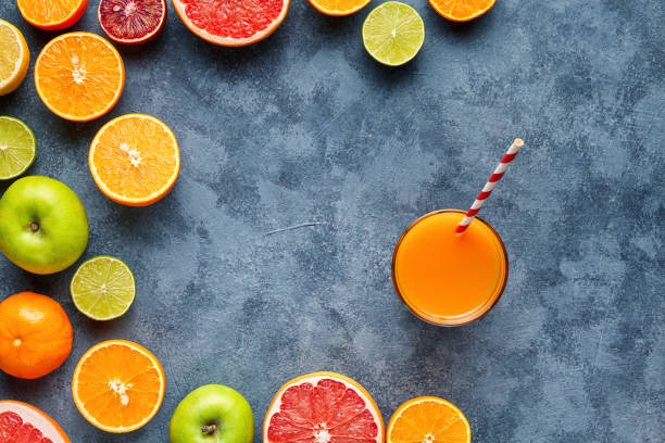 istock Juice or smoothie with citrus fruit, apple, grapefruit on blue background. Top view, selective focus. Detox, dieting, clean eating, vegetarian, vegan, fitnes healthy concept 670563708