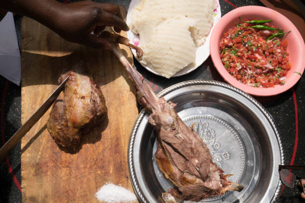 Grilled lamb meat with tomato salad and ugali, Kenya