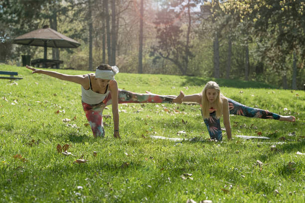 istock Two girls doing yoga 670564032