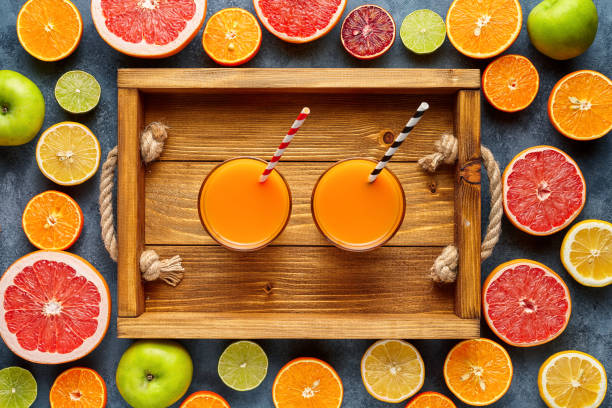 istock Fresh juice or smoothie with organic citrus fruit, apple, grapefruit on light background. Top view, selective focus. Detox, dieting, clean eating, vegetarian, vegan, fitnes healthy concept 670564266