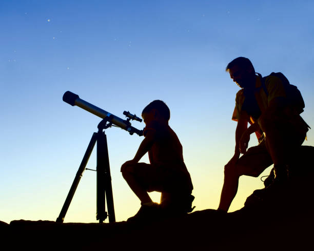 istock Father and Son with Telescope 670570534