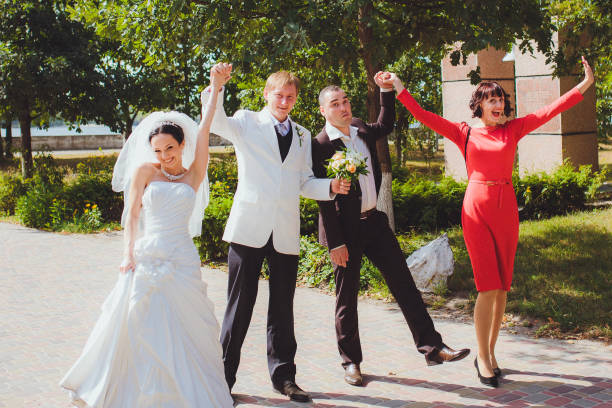istock Merry bride and groom with friends 670574060
