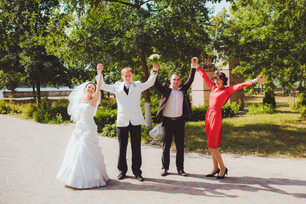 istock It's a fun wedding. Celebrating bride and groom with friends 670574062