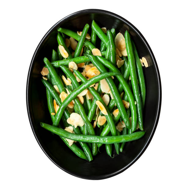 Green Beans with Toasted Almonds in Black Bowl Green beans with toasted almonds, in black bowl. Isolated on white, top view. green bean stock pictures, royalty-free photos & images
