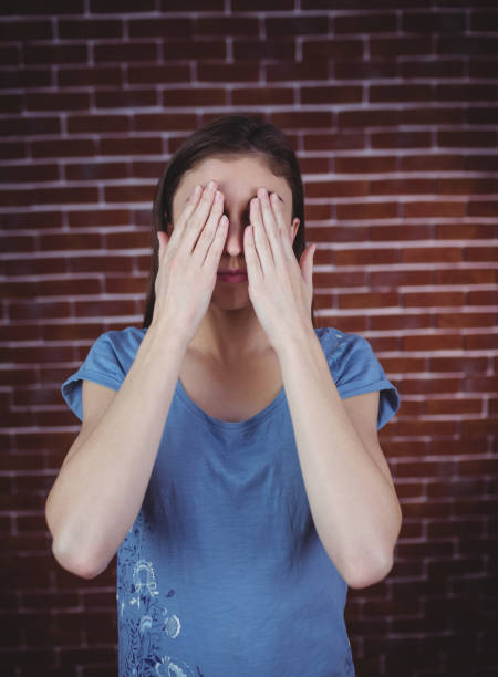 istock Pretty brunette with hands over eyes 670581314