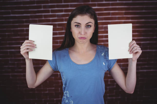 istock Pretty brunette holding two pages 670581434