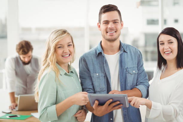 istock Portrait of happy Business professionals using digital tablet 670581478