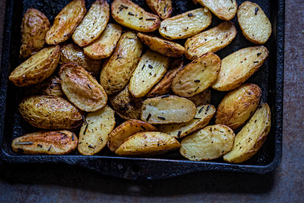 Roasted potatoes with herbs stock photo