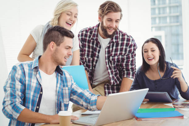 istock Happy business people working on laptop 670587818