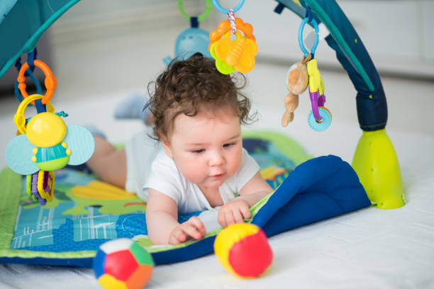 istock Baby boy playing with baseball ball 670587936