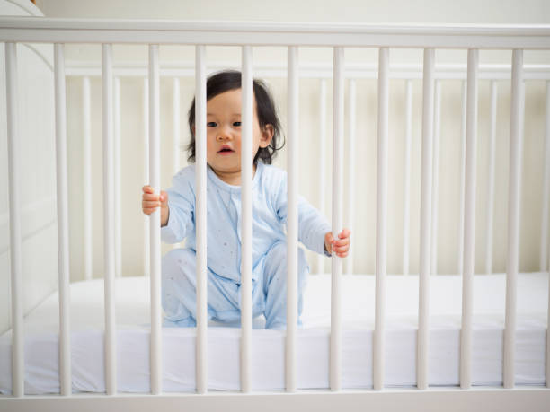 istock baby girl in cot 670588320