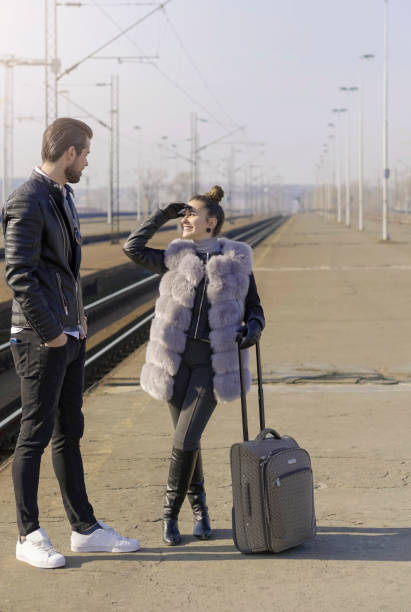 istock Young couple on a railroad station 670588398
