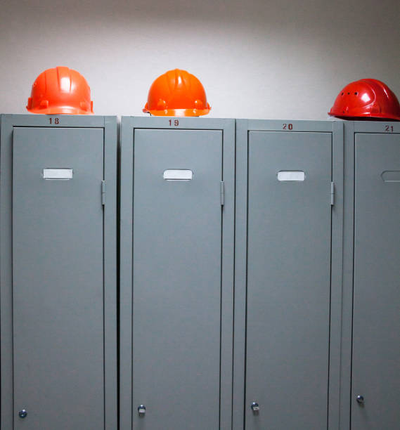 istock Metal lockers and plastic hard hats 670591850