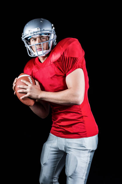 istock Determined American football player holding ball 670594278