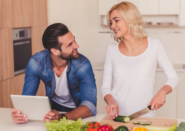 istock Beautiful couple cooking 670594340