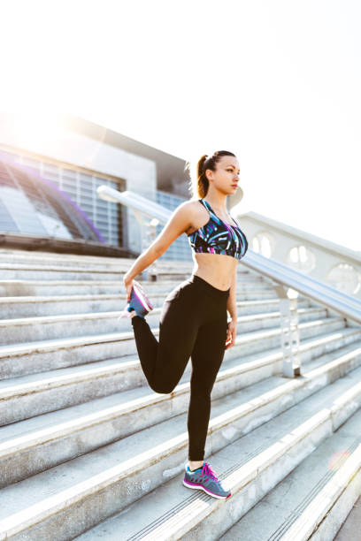 istock fitness woman stretching on the steps 670594366