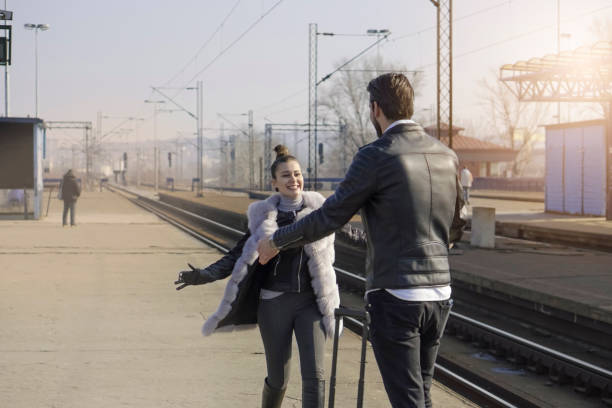 istock Young couple on a railroad station 670594432