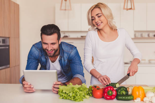 istock Beautiful couple cooking 670596852