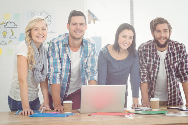 istock Portrait of smiling business people while standing 670597098