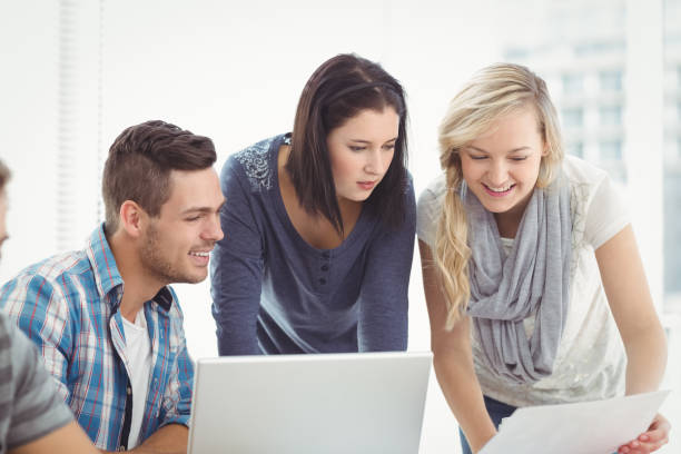 istock Business people using laptop at desk 670597744