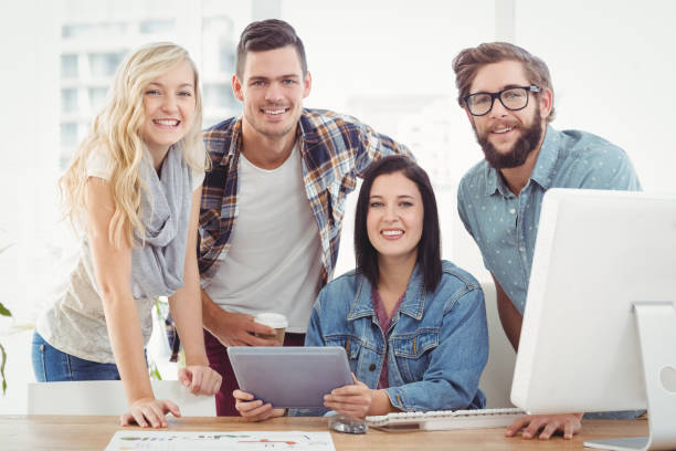 istock Portrait of smiling business professionals using digital tablet 670600822