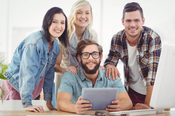 istock Portrait of smiling business people using digital tablet 670600852