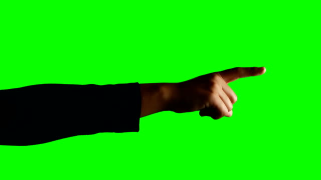 Person making hand gesture against green screen background