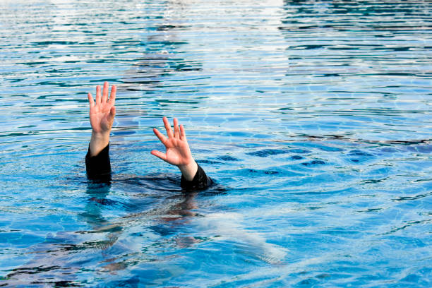 istock two hand of drowning man  in swimming pool  asking for help 670614872