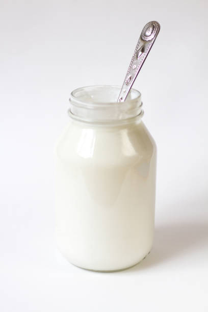 istock Glass Jar of Greek Yogurt, White Background, Spoon Inside 670618118
