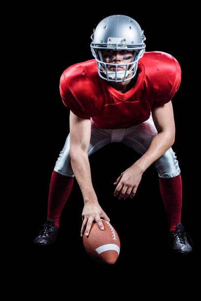 istock American football player placing ball while playing 670622078