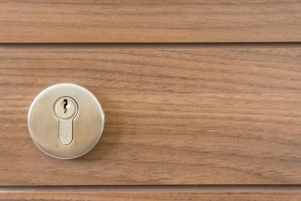 istock abstract space silver keyway on wood door close-up 670622094